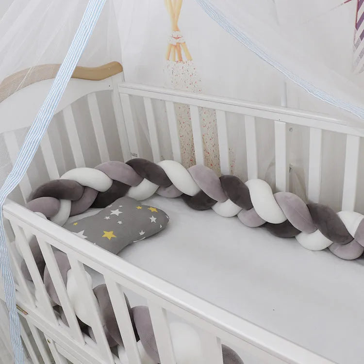 Braided knot style baby cot bumper in spandex crystal velvet fabric, shown in a light grey colour.