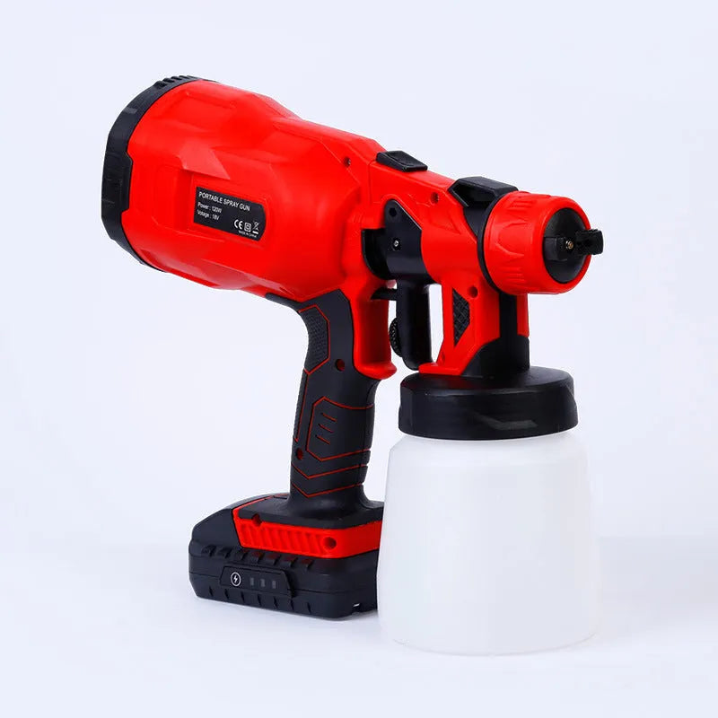 Blue cordless automatic paint spray gun with 800ml can and 1.8mm nozzle on a workbench.