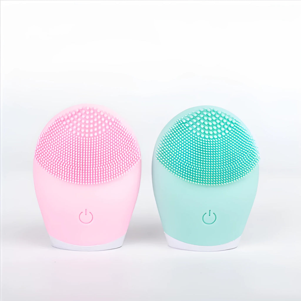 Electric ultrasonic silicone facial cleanser in pink, compact 8.2cm x 7cm x 3.5cm, with USB cable and manual