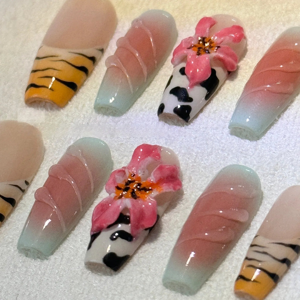 Set of zebra pattern lily hand-carved artificial nail tips with flower and leopard print designs in sizes XS to L