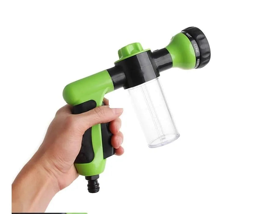 Green high-pressure foam spray gun with adjustable nozzle and attached water pipe for car and garden cleaning.