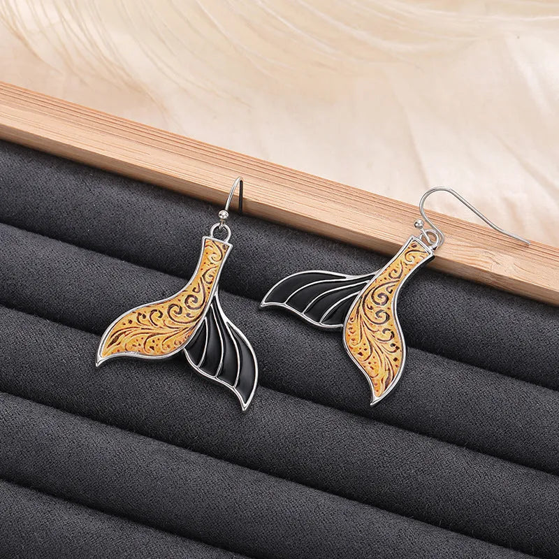 Women's retro fishtail and whale design alloy earrings in white gold colour E4143.