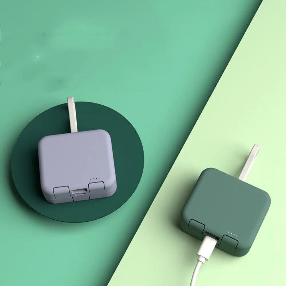Handbag back clip power bank with flip-out phone stand, shown in blue, green, red, and white colour options.