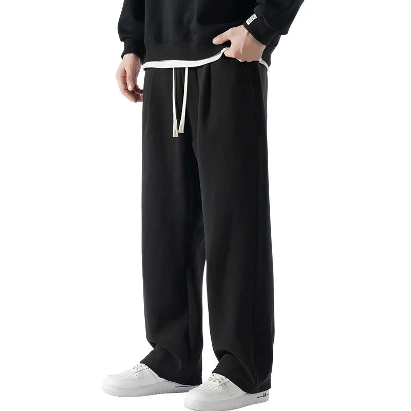 Man wearing apricot double-sided polar fleece lined loose fit casual sports trousers.