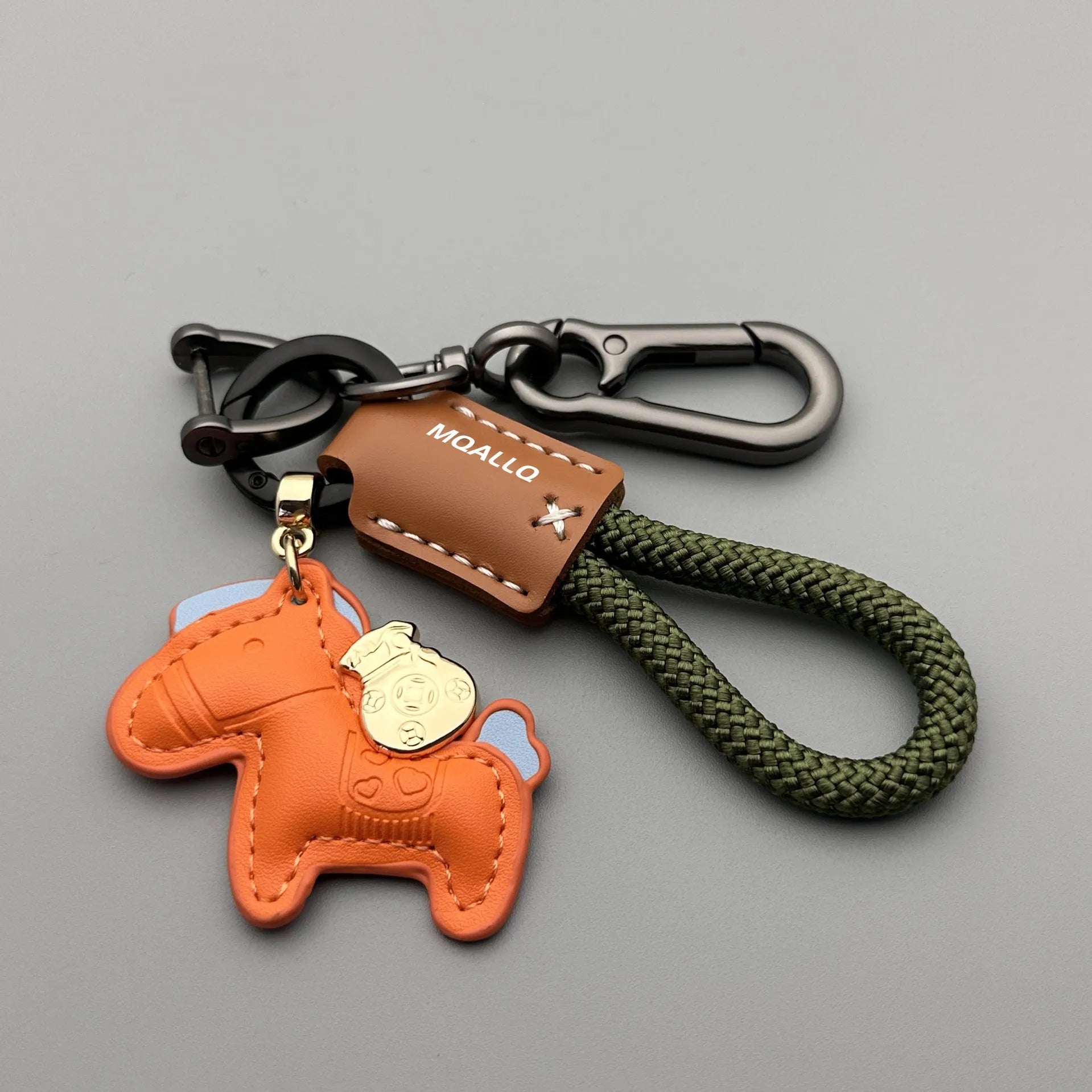 Handmade brown cowhide key ring pendant with a zinc alloy pony belt buckle and green flanelle rope.