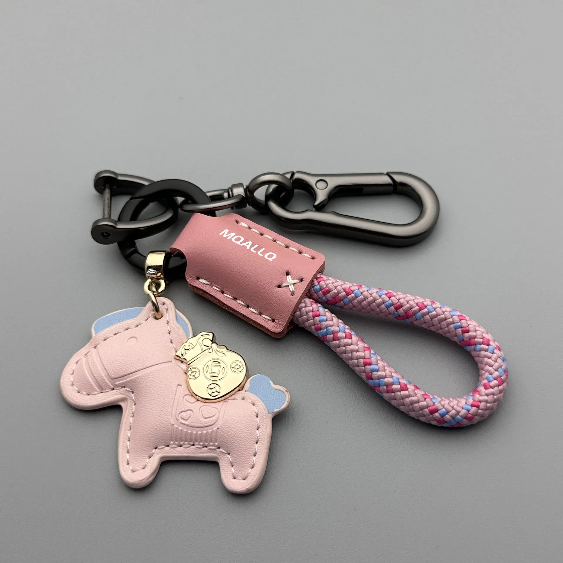 Handmade brown cowhide key ring pendant with a zinc alloy pony belt buckle and green flanelle rope.