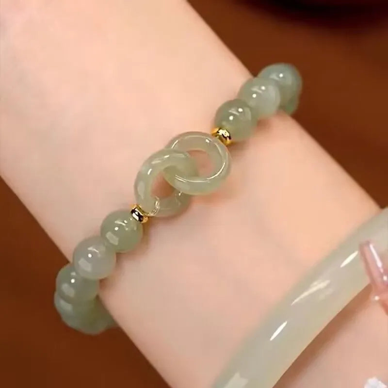 Chinese style glass bead bracelet with bamboo leaf design and manual craftsmanship details.