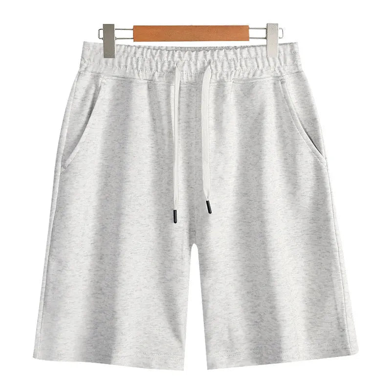 Men's and women's straight cut cotton sports shorts in multiple colours on a plain background.