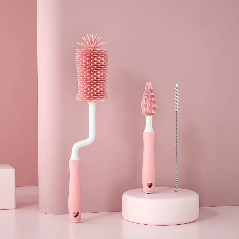 Baby bottle brush set with silicone bristles and a small straw cleaning brush in pink, blue, and yellow colours.