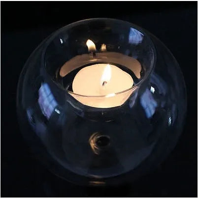 Handmade round clear glass candle holder on a table