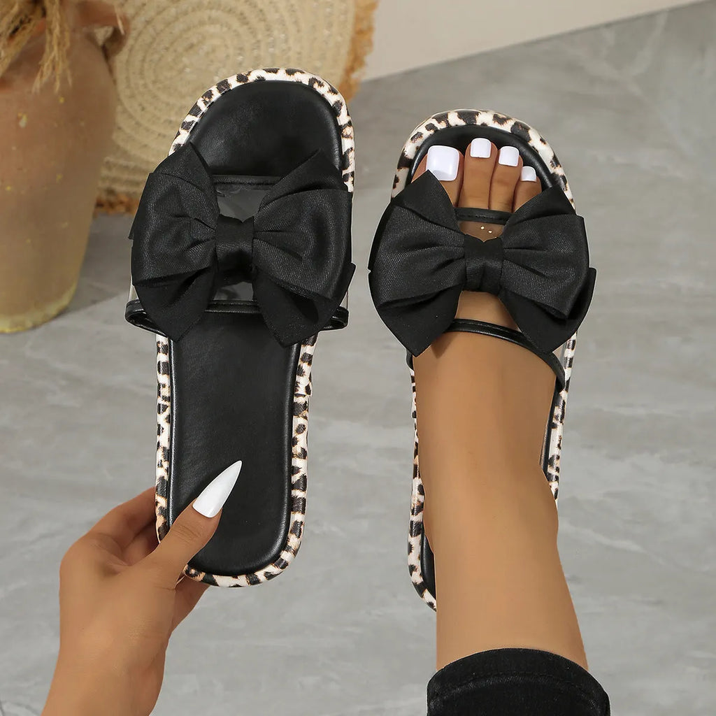 Women's leopard print beach slippers with thick rubber sole and round-toe design in black and white