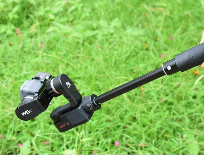 Black retractable selfie stick extended with smartphone attached in adjustable clamp