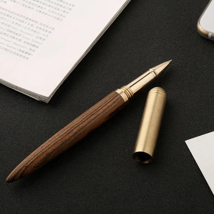 Brass sandalwood signature pen 14cm with wood barrel on a flat surface