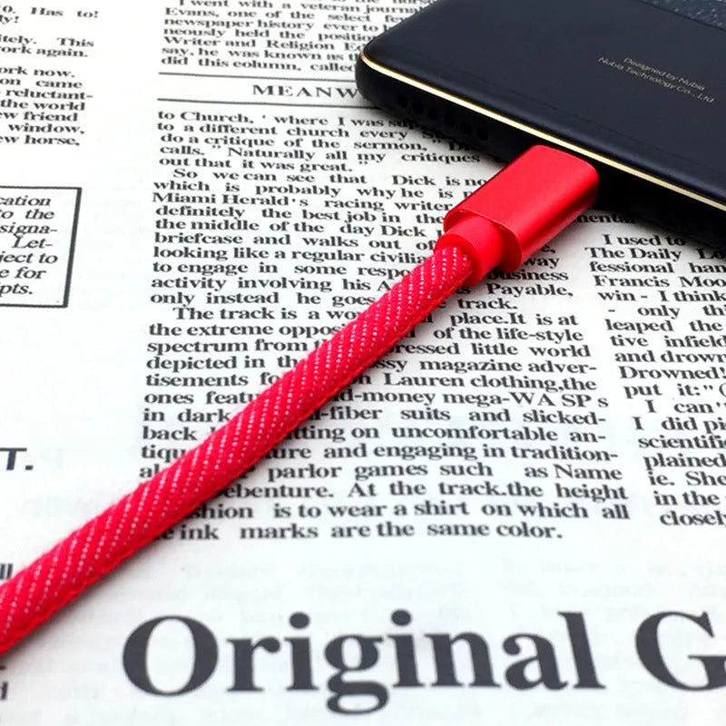 Cowboy-style denim USB-C charging cable with aluminium connectors in black, blue, or red.