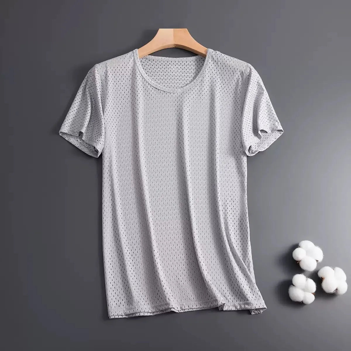 Man wearing a solid colour ice silk short sleeve crew neck T-shirt in a loose fit.