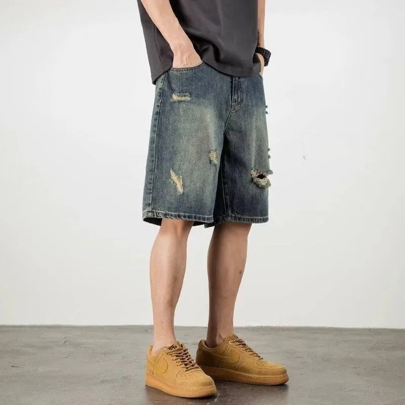 Blue distressed denim men's shorts with a loose retro fit and hole detailing