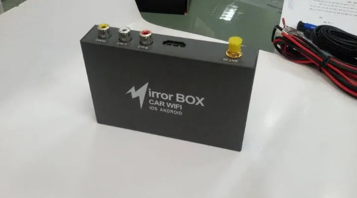 Black car mirror link box host unit with connecting AV cable, power cable, and antenna.