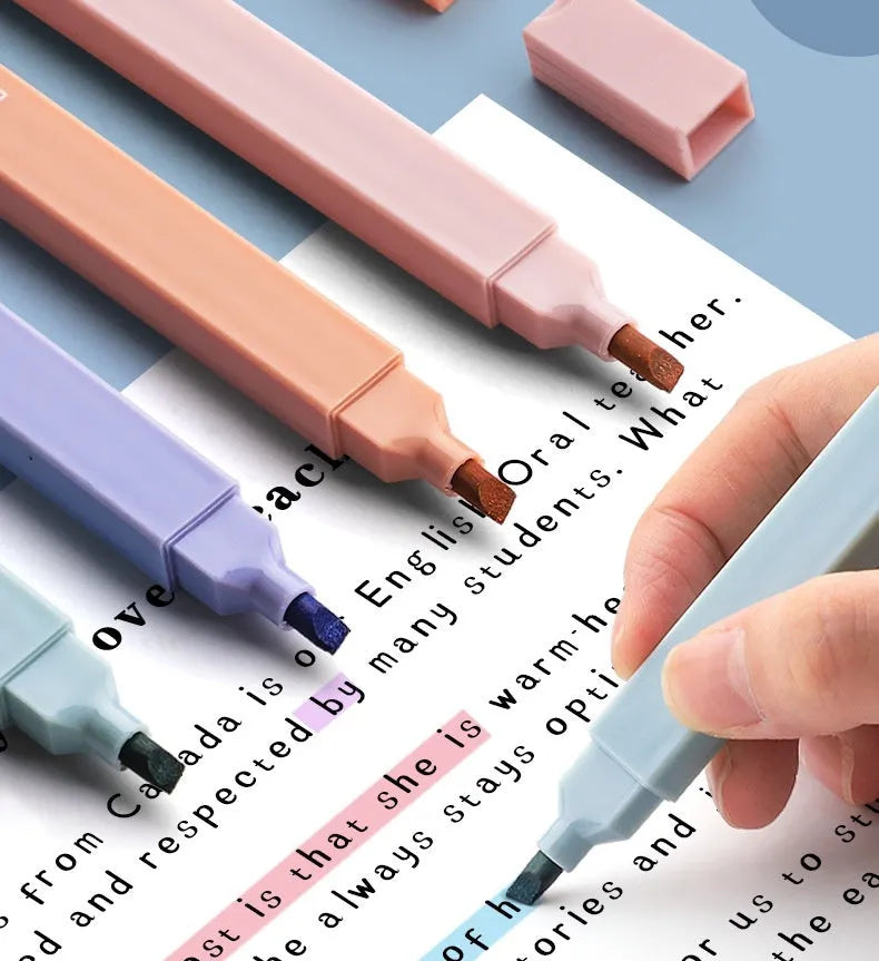 Set of double-tipped fluorescent marking pens in mixed colours on a white background.