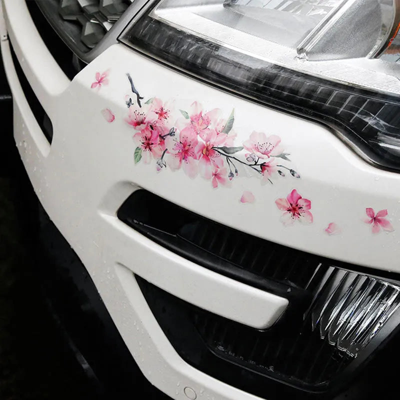 Close-up of a cherry blossom flower pattern on a PVC car sticker, shown with a peel-off backing.