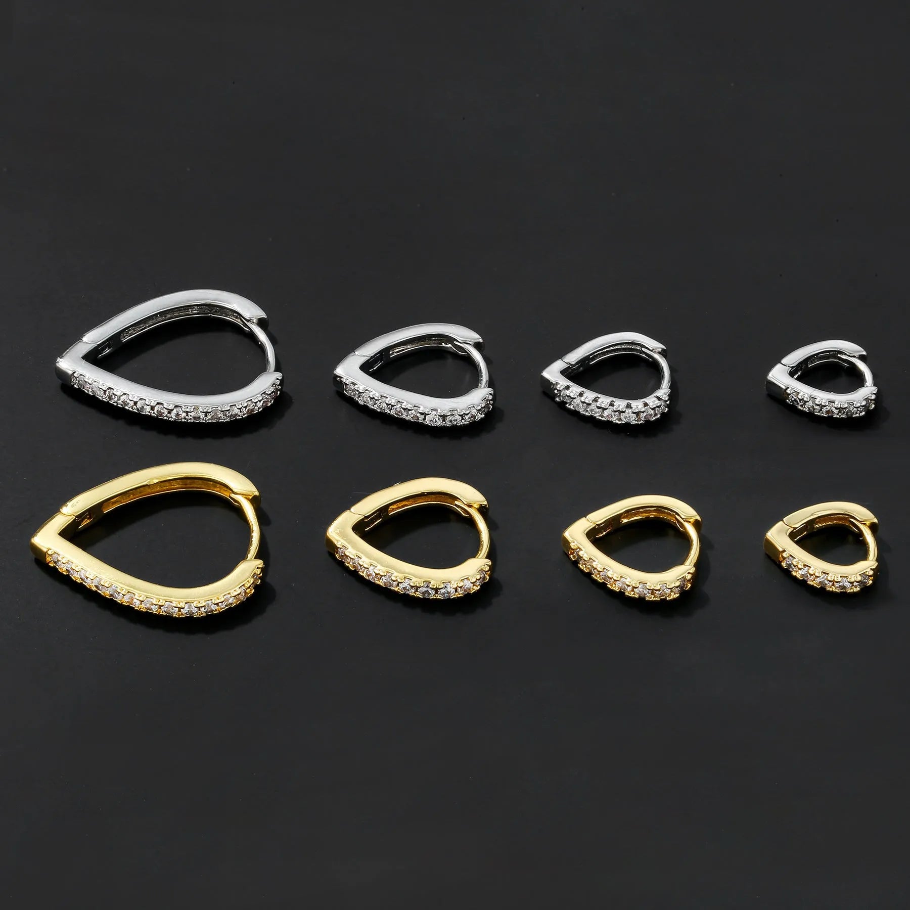 Geometric heart-shaped copper ear clip with electroplated gold or white finish on a white background.