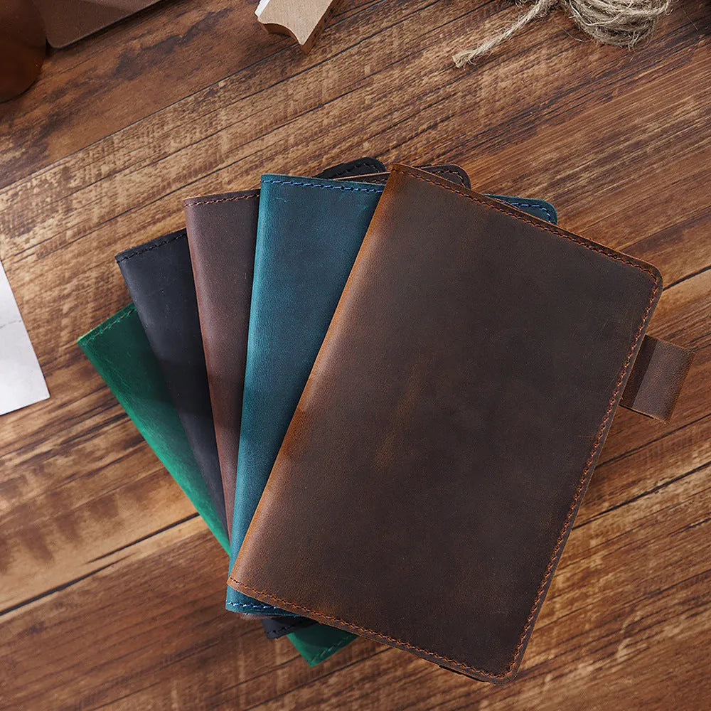 Handmade kraft notebook with cowhide cover in choice of six colours, showing open pages of wood-free paper.