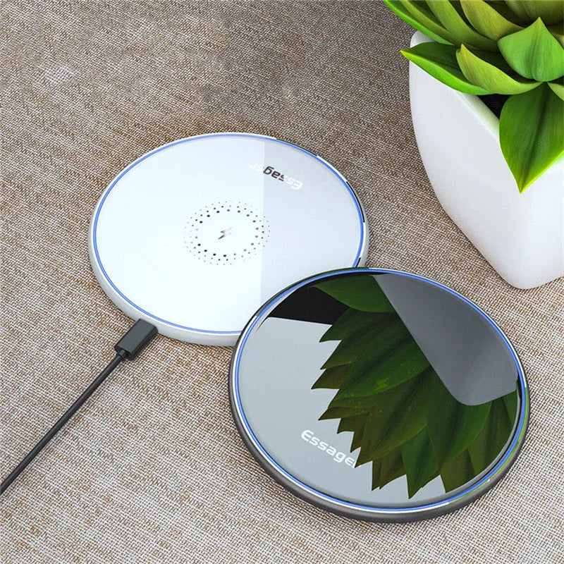 Black Qi fast wireless charging pad for smartphones on a desk