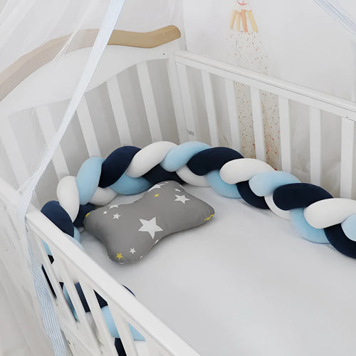 Braided knot style baby cot bumper in spandex crystal velvet fabric, shown in a light grey colour.
