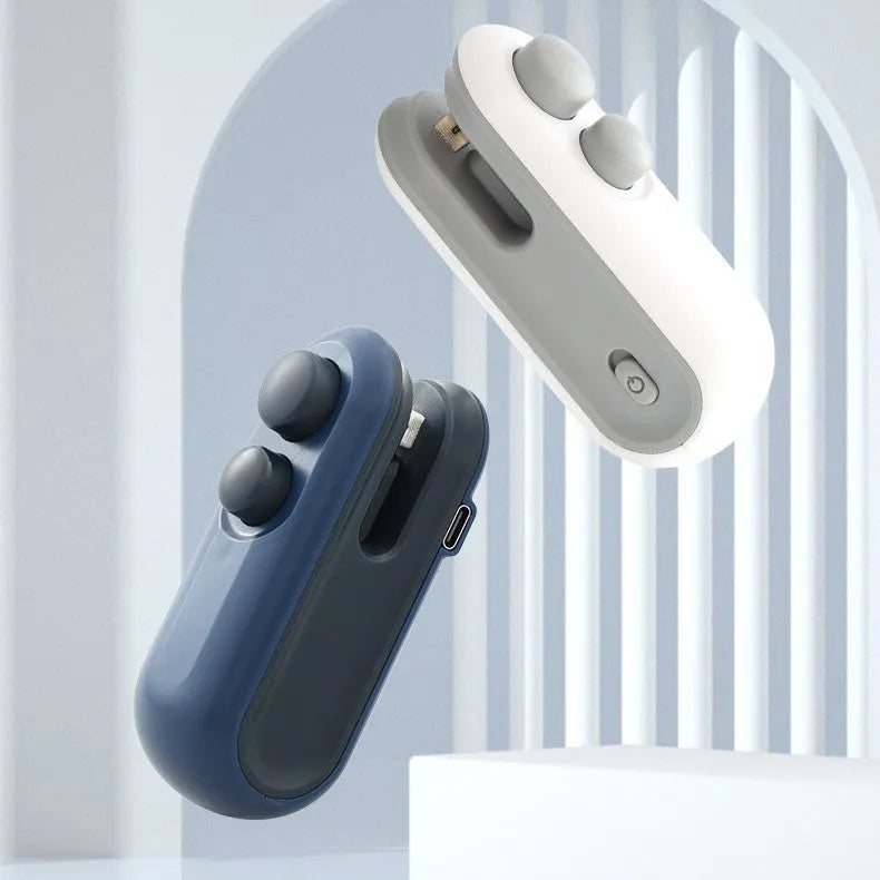 Blue handheld USB rechargeable heat sealer and bag cutter on a kitchen counter.