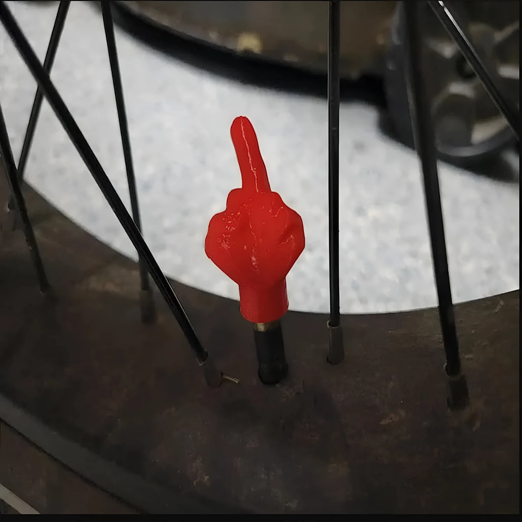 Four latex tyre valve dust caps in skin colour and black colours