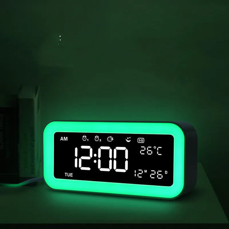 Blue rectangular LED atmosphere light alarm clock with digital display on a table.