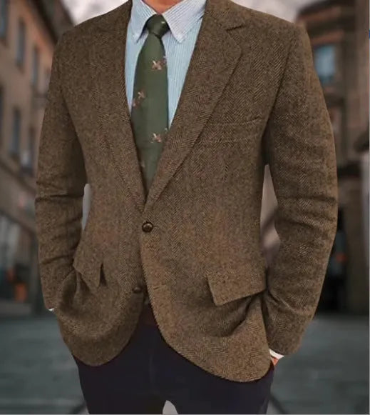 Men's brown herringbone pattern retro suit jacket with long sleeves on a hanger.