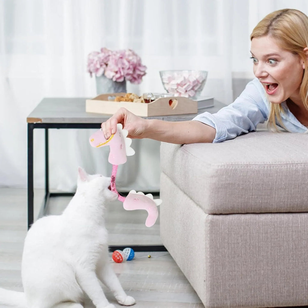 Four cat chew toys including plush mouse, fish, bunny, and chew toy in pink, purple, and yellow colours