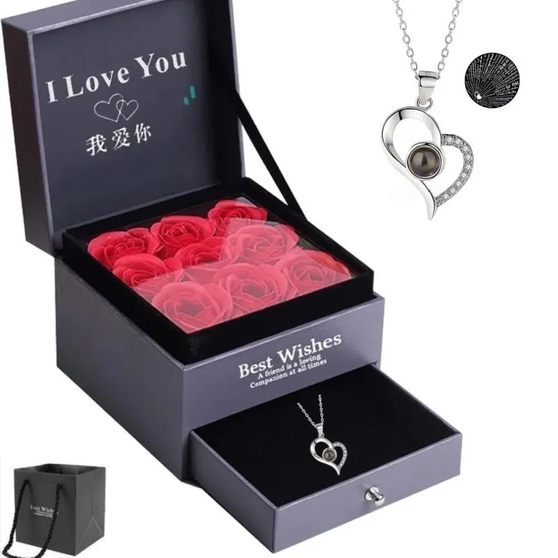 Rose gold heart-shaped projection necklace in copper with O chain, displaying 100 languages love message.
