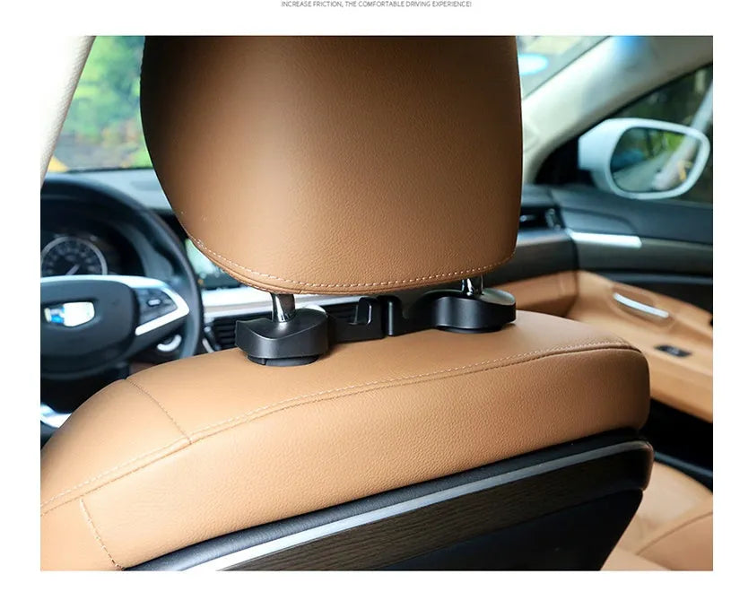Pair of black plastic concealed car seat back hooks on a car seat back holding a bag