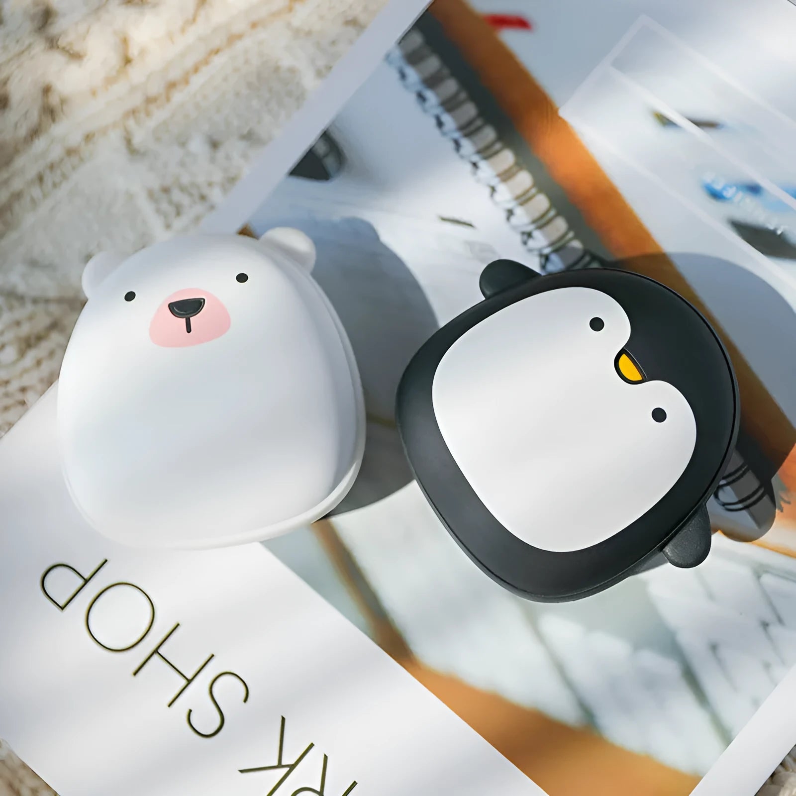 Cartoon penguin polar bear design USB rechargeable electric hand warmers showing front and side views