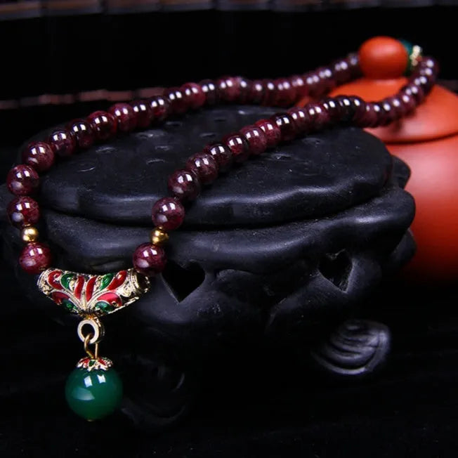 Natural garnet bracelet with 7mm stones, double ring settings and golden toad charm