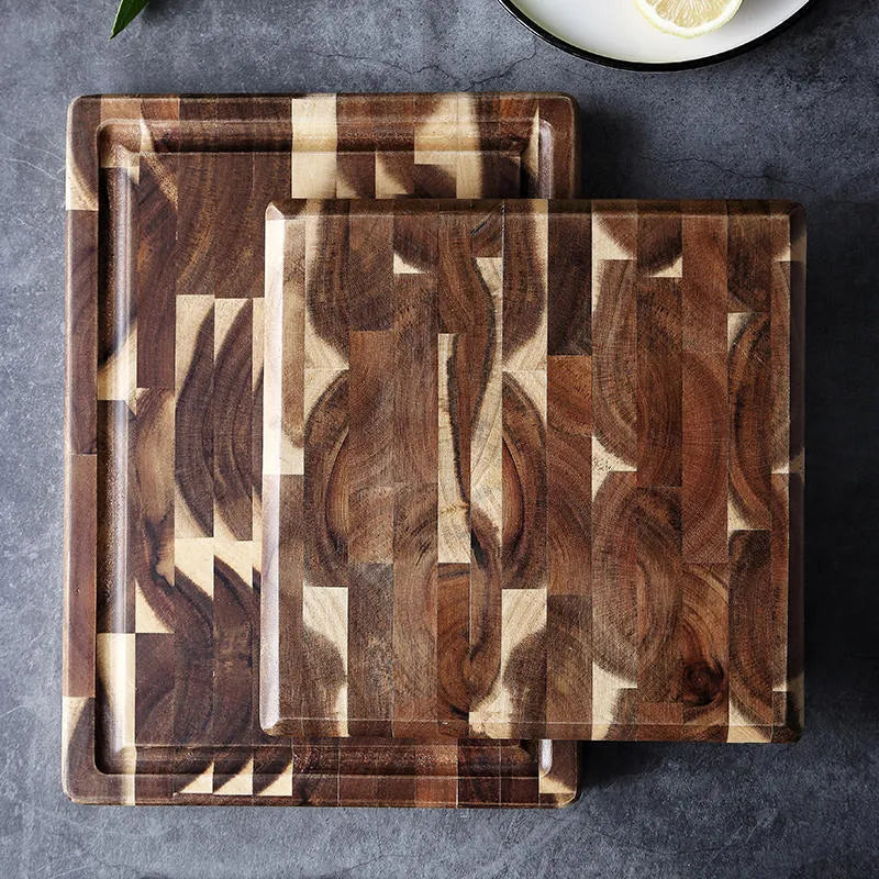 Brown solid wood chopping board with parquet pattern, shown on a kitchen countertop.
