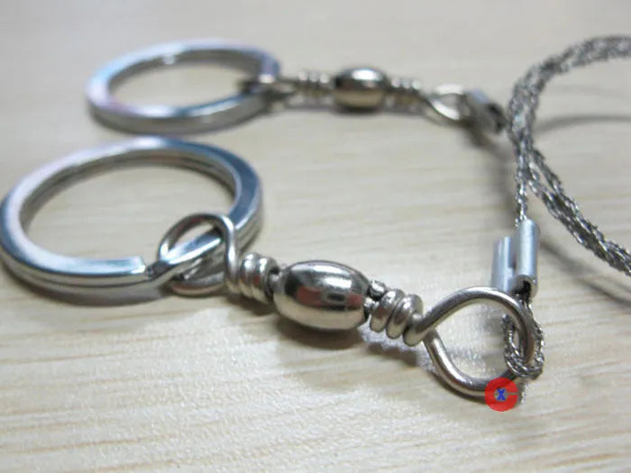 Stainless steel survival wire saw with thumb rings, showing extended length of 70cm.