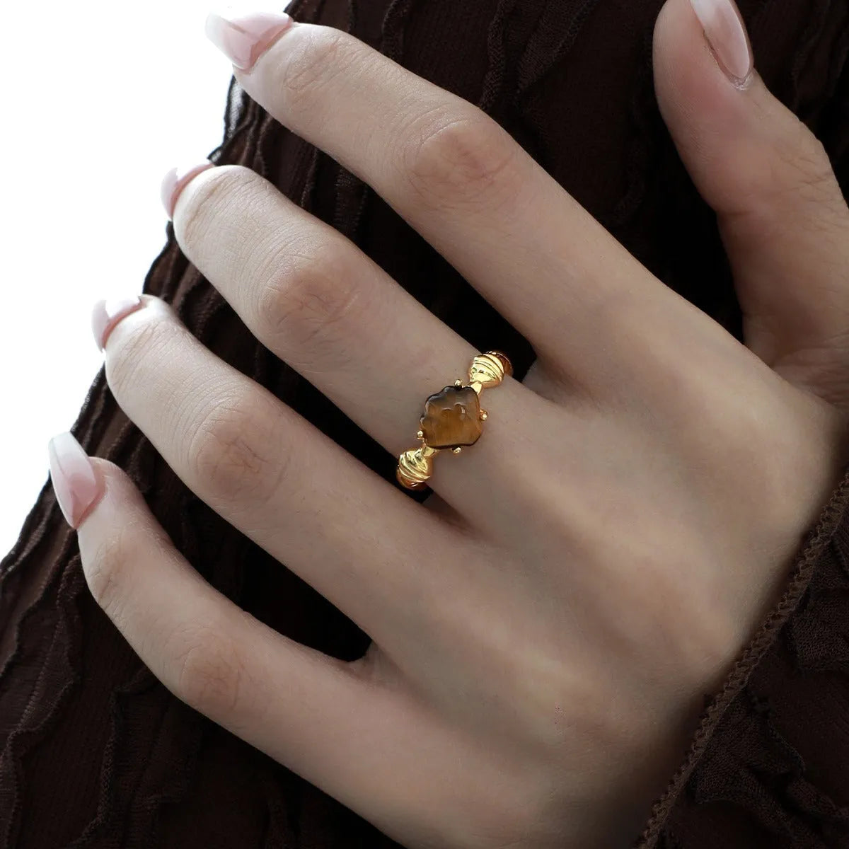 Adjustable silver ring featuring a carved shell and tiger eye stone design in a choice of finishes.