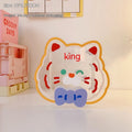 Clear square acrylic storage box with cute decorative design, shown holding pens and small items on a desk.