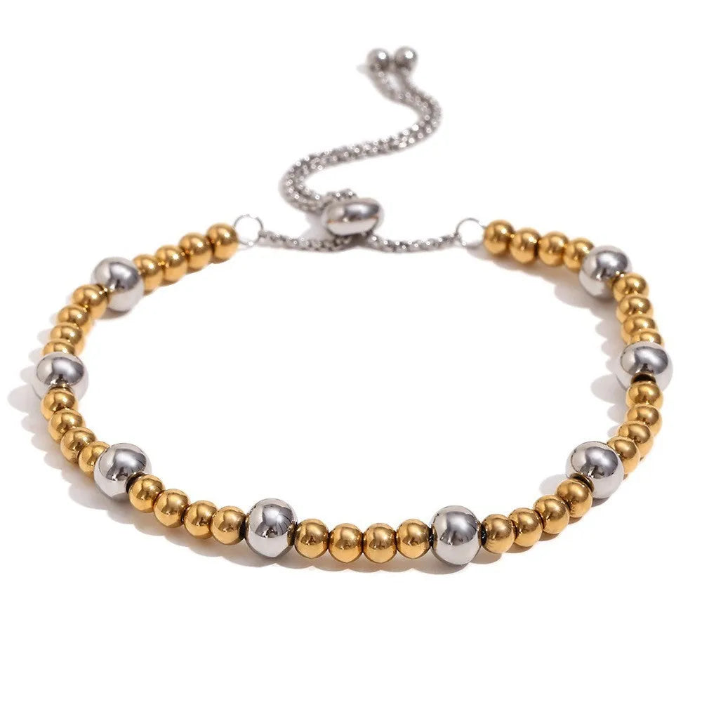 Gold tone electroplated stainless steel jewellery set with geometric shapes including earrings, bracelet and necklace