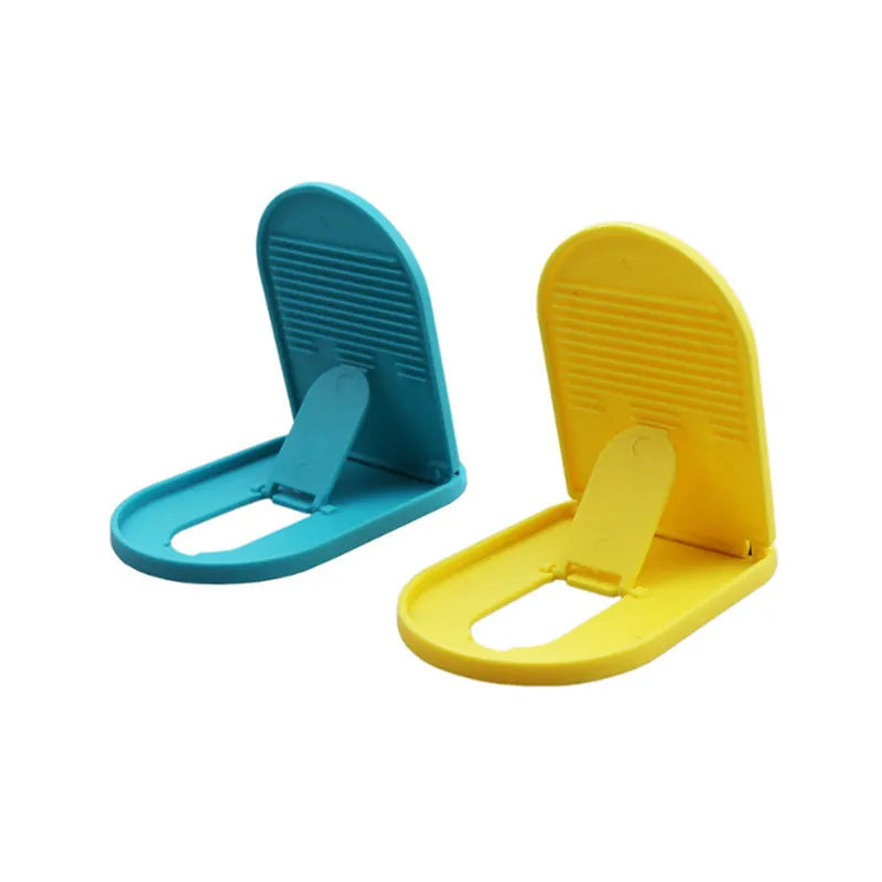 Plastic mobile phone stand with lazy bracket design in assorted colours on a desk.