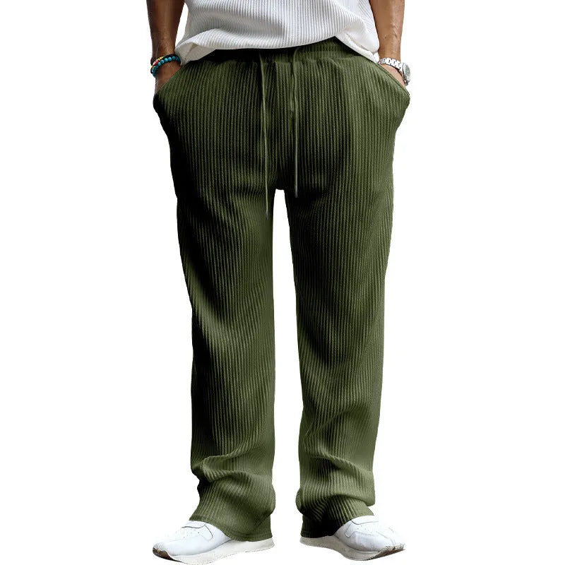 Man wearing loose-fit high-waisted straight leg casual trousers in Army Green.