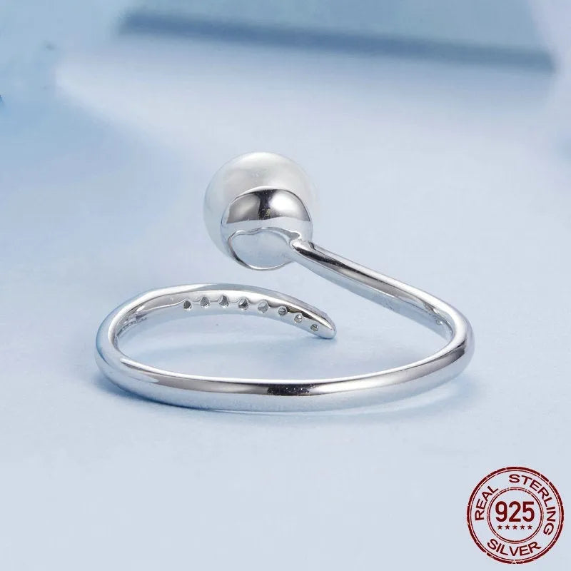 S925 sterling silver adjustable ring with natural shell pearl centrepiece showing open loop design