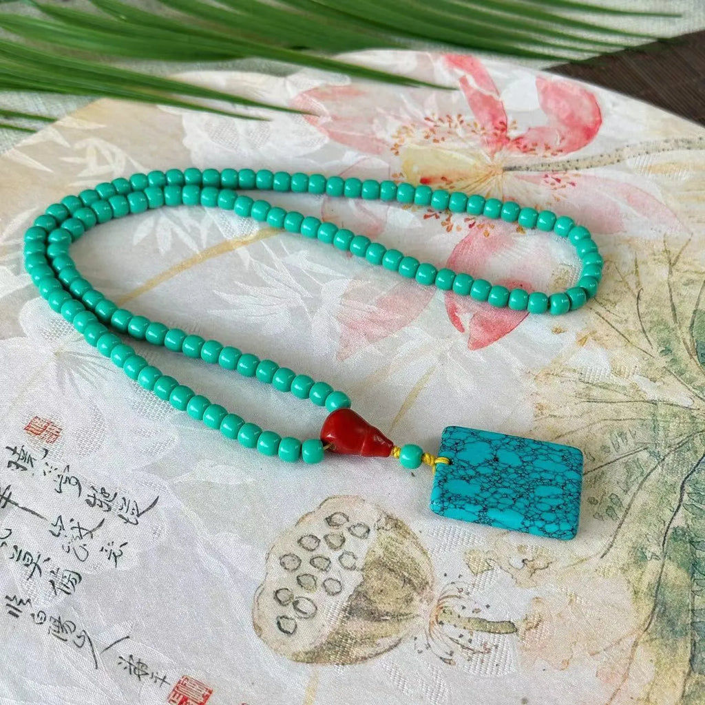 Turquoise stone mesh flower lucky pendant on an adjustable ball bead necklace chain.