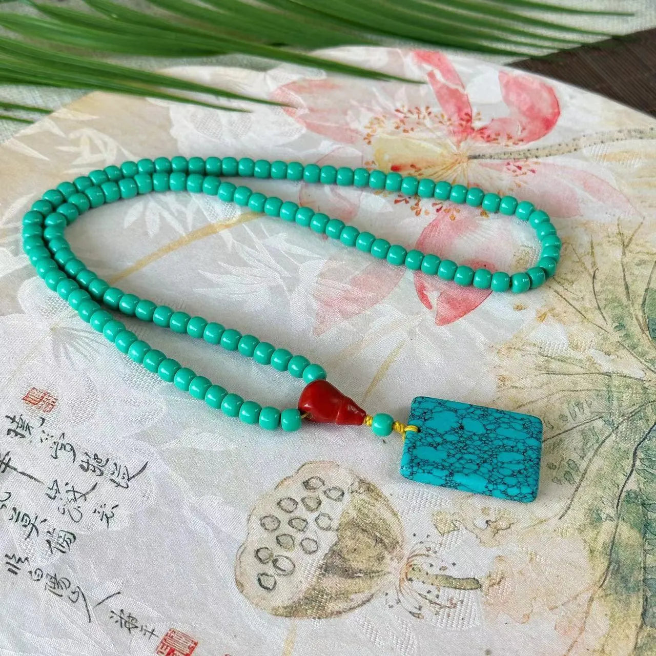 Turquoise stone mesh flower lucky pendant on an adjustable ball bead necklace chain.