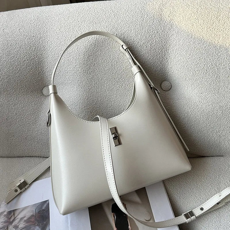 Soft genuine leather dumpling-shaped crossbody bag in apricot colour with visible stitching.