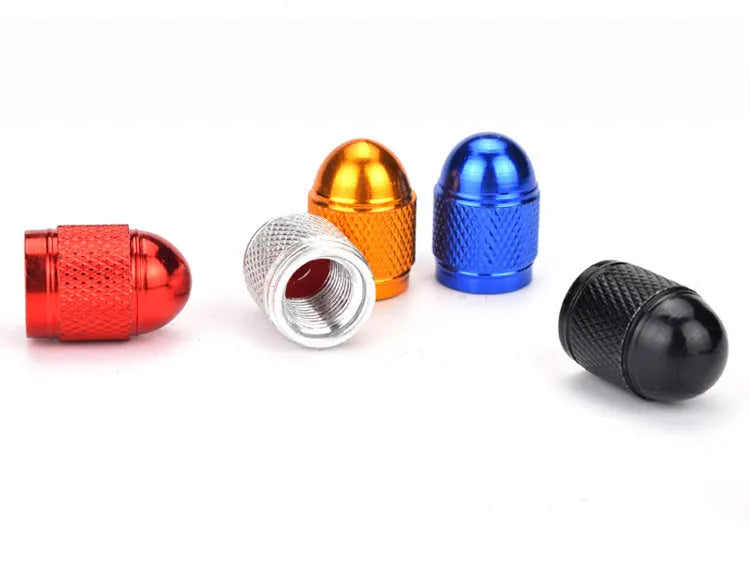 Aluminium mountain bike tyre valve cap in multiple colours on a Schrader valve.