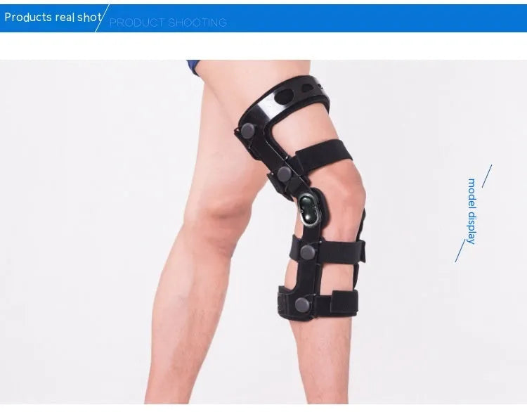 Black anterior ligament knee pad with visible metal stabiliser, shown in a left-leg size.