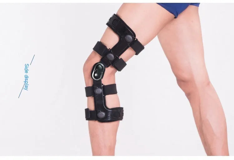 Black anterior ligament knee pad with visible metal stabiliser, shown in a left-leg size.